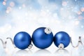 Christmas and New Year greeting card. Holiday ornament, winter decoration. Blue christmas baubles with silver ribbon over bokeh Royalty Free Stock Photo