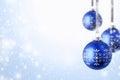 Christmas and New Year greeting card. Holiday ornament, winter decoration. Blue christmas balls hanging on ribbon over snow Royalty Free Stock Photo