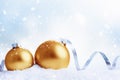Christmas and New Year greeting card. Gold christmas balls with ribbon over snow background, Royalty Free Stock Photo