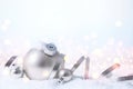 Christmas and New Year greeting card. Holiday ornament, winter decoration. Silver christmas balls with ribbon over bokeh lights Royalty Free Stock Photo