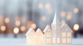 Christmas and New Year greeting card. Little white houses with christmas lights bokeh background.