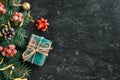 Christmas and New Year holiday background with gift box, fir tree branches and seasonal decorations on chalkboard. Flat Royalty Free Stock Photo
