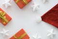 Christmas and New Year holiday composition with gift boxes, santa hat, ribbons, stars on the white background. Top view Royalty Free Stock Photo