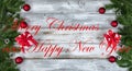 Christmas or New Year holiday concept background with evergreen branches and other decorations on both side borders plus text