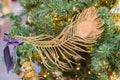 Christmas and New Year holidays background. Christmas tree decorated with gpld feather. Celebration concept