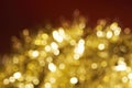 Christmas and New Year holidays blurred golden sparkles on red background Royalty Free Stock Photo