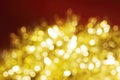Christmas and New Year holidays blurred golden sparkles on red background Royalty Free Stock Photo