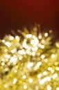 Christmas and New Year holidays blurred golden sparkles on red background Royalty Free Stock Photo