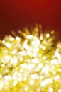 Christmas and New Year holidays blurred golden sparkles on red background Royalty Free Stock Photo