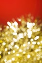 Christmas and New Year holidays blurred golden sparkles on red background Royalty Free Stock Photo