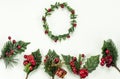 Christmas New Year holidays composition: green holiday wreath, five green branches, red berries and gift Royalty Free Stock Photo