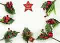 Christmas New Year holidays composition: red star, 7 green branches, red berries and gift Royalty Free Stock Photo