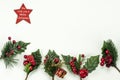 Christmas New Year holidays composition: red star, five green branches, red berries and gift Royalty Free Stock Photo