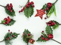 Christmas New Year holidays composition: red star, 8 green holiday branches, red berries and gift Royalty Free Stock Photo