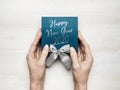 Christmas New Year Holidays concept top view. Unrecognizable woman wrapping draws a gift box on white wooden table, point of view Royalty Free Stock Photo