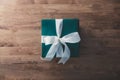 Christmas and New Year holidays gift box wrapped with green paper and white ribbon Royalty Free Stock Photo