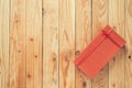 Christmas and New Year holidays gift box wrapped with red paper and yellow ribbon bow on wood table - top view on wooden table top Royalty Free Stock Photo