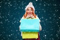 Christmas and New Year holidays.. Shopping woman holding color bags and on winter background with snow in black friday Royalty Free Stock Photo