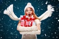 Christmas and New Year holidays. Surprised woman holding gift boxes on winter background with snow in black friday. Sale Royalty Free Stock Photo