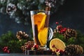 Christmas or New Year hot winter drink, spicy grog cocktail, punch or mulled wine with tea, lemon, rum, cinnamon, anise. Rustic