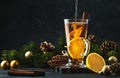 Christmas or New Year hot winter drink, spicy grog cocktail, punch or mulled wine with tea, lemon, rum, cinnamon, anise. Rustic Royalty Free Stock Photo