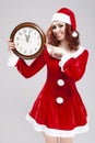 Christmas and New Year Ideas. Smiling Happy Snow Maiden with Round Big Closk Showing Five Remaing Minutes To Christmas Against Royalty Free Stock Photo