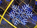 Christmas and new year illumination on city streets. Bright snowflakes in festive lights. A magical Christmas night.