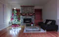 Christmas or New Year interior background with bright fir tree and glowing fireplace