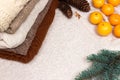 Christmas and New Year Mandarins in the snow next to the multi-colored sweaters, pine cones and Christmas tree branch Royalty Free Stock Photo