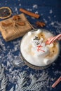 Christmas and New Year. Marshmallow snowman in hot latte in a mug. Vertical photo