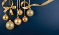 Golden and blue Glass Balls hanging on ribbon on Navy blue background with copy space for text Royalty Free Stock Photo