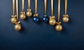 Golden and blue Glass Balls hanging on ribbon on Navy blue background with copy space for text Royalty Free Stock Photo