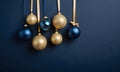 Golden and blue Glass Balls hanging on ribbon on Navy blue background with copy space for text Royalty Free Stock Photo