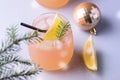 Christmas or New Year Party Cocktail with Citrus Glass of Grapfruit Beverage Decorated with Slice of Lemon and Fir Branches Straw