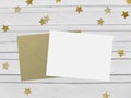 Christmas, New Year party mockup scene with golden star shape glittering confetti, blank paper and envelope. White