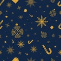 Seamless pattern with gold stars, snowflakes, christmas tree balls, caramel cane, presents on a dark blue background. Royalty Free Stock Photo