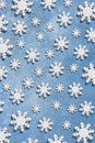 Christmas and New Year pattern made of wooden snowflakes on a blue background. Christmas, winter, new year concept. Flat lay, top Royalty Free Stock Photo