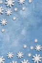 Christmas and New Year pattern made of wooden snowflakes on a blue background. Christmas, winter, new year concept. Flat lay, top Royalty Free Stock Photo