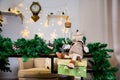Christmas and New Year photo studio, green tree, garlands, glass for milk, soft chair, plush toy, white wall (3). Royalty Free Stock Photo