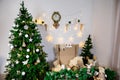 Christmas and New Year photo studio, green tree, soft chair, garlands stars, clock on a white wall (1). Royalty Free Stock Photo