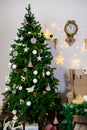 Christmas and New Year photo studio, green tree, soft chair, garlands stars, clock on a white wall (3). Royalty Free Stock Photo