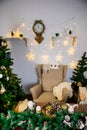 Christmas and New Year photo studio, green tree, soft chair, garlands stars, clock on a white wall (5). Royalty Free Stock Photo