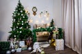 Christmas and New Year photo studio, green tree, soft chair, garlands stars, clock on a white wall (9). Royalty Free Stock Photo
