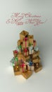 Christmas and New Year presents in the pile with the shape of the Christmas tree. With red greeting text