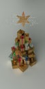 Christmas and New Year presents in the pile with the shape of the Christmas tree. With white greeting text