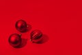 Christmas and New Year red balls with copy space on red backdrop. Hard light Royalty Free Stock Photo