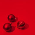 Christmas and New Year red balls with copy space on red backdrop. Hard light Royalty Free Stock Photo
