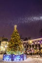 Christmas and New Year`s big fir-tree with toys and festoons from VTB Bank in the evening in snowfall. Ilyinsky Square. Moscow.