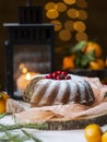 Christmas and new year`s cake with berries and lantern behind