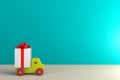 Christmas and New Year`s Day, Gift box with red ribbon and car on wood table Royalty Free Stock Photo